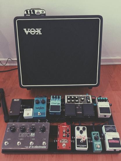 A bunch of guitar pedals on a PedalTrain, and a Vox MV50 Clean going into a single 12" speaker cab.