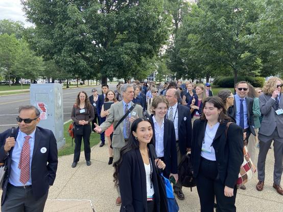 Enthusiastic volunteers dressed in business attire walking toward the US Capitol