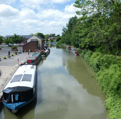 A canal, lined with narrow boats