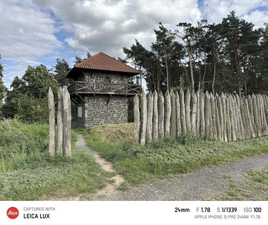 Der Limesturm bei Watzenborn-Steinberg, Gemeinde Pohlheim, Landkreis Gießen. Im Vordergrund steht eine Palisade aus Baumstämmen. Zwischen den Baumstämmen für ein Weg zum Turm.