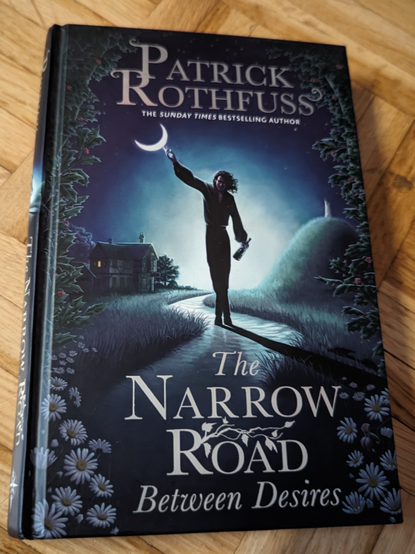 A photo of hardcover book "The Narrow Road Between Desires" by Patrik Rothfuss