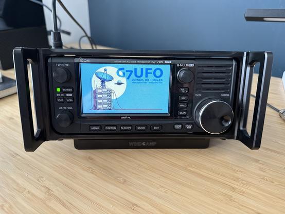 An Icom IC-705 radio in an ARK cage with a custom startup screen.