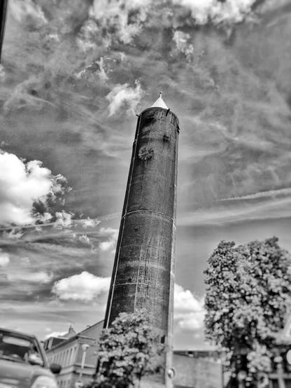 A black and white image of a church tower at the Rhein in Krefeld that is under restoration.
