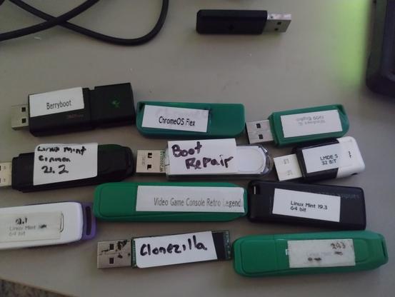 12 USB Flash drives with various stickers on them with the Boot OS that is installed. A 13th flash drive is in the background with nothing on it at all (8gb stick)

Berryboot is for the Raspberry PI, ChromeOS Flex is an old version, Windows 10 1909 fixed a boot issue I was having with a linux install (Weird huh? - Yeah I thought so too, Boot Repair didn't even fix it). There are 4 or 5 different Linux Mint installs dating back to 19.3, Clonezilla and finally a Video Game Console Retro Disk