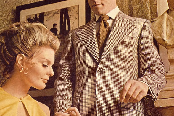 1970 A Man and a Woman in a Room

The image shows two people, one standing and one sitting.
They appear to be engaged in a conversation.
The standing person is wearing a patterned suit with a tie and has short hair, while the seated person is wearing a yellow top and has blonde hair styled up.
Both individuals seem to be dressed in attire from an earlier era, possibly the 1960s or 1970s.
There are no visible texts on the image.