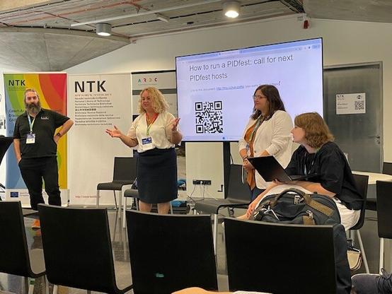 Four presenters in front of a screen reading How to run a PIDfest call for next PIDfest hosts