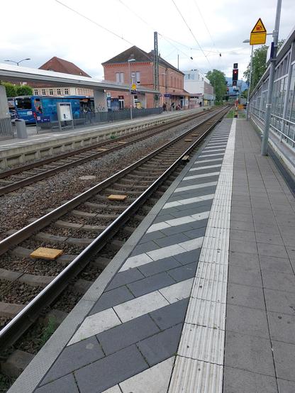 Blick vom Bahnsteig auf Gleis 1 und 2 im Bahnhof Emmendingen mit Blick auf die Ausfahrsignale mit ETCS Stop Marker. Im Gleis liegt ein halbes Dutzend Balisen pro Gleis.