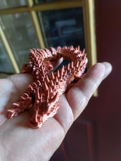 bronze(ish) ice dragon printed with rainbow PLA.