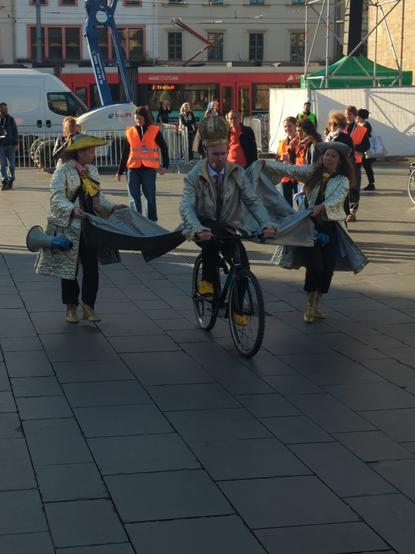 während der Sprechprobe hat der König ein Fahrrad von einem Zuschauer übernommen, fährt damit und improvisiert mit etwas abweichendem Text, während 2lilliput seinen goldenen Mantel ausbreiten.