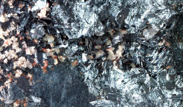 Close up view on some of the plate like silver crystals, showing faces on the edges.