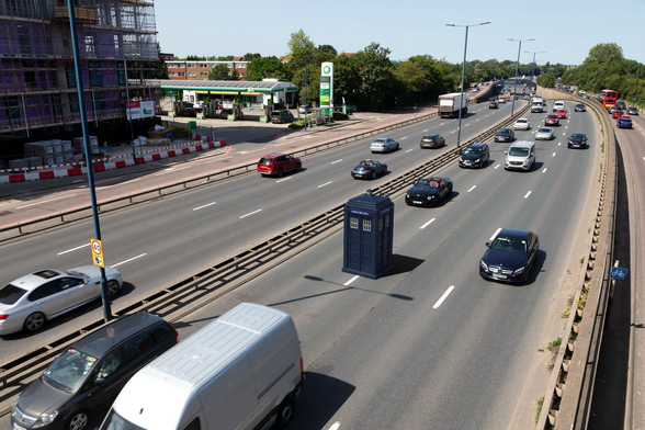 Composite of a police box on a dual carriageway