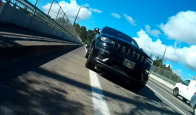 jeep with oregon plate WC 44127, over the bike lane paint