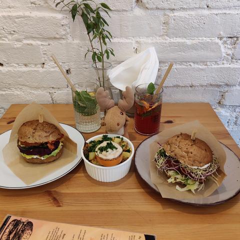 Lentil burger, elderflower limonade, baked potatoes with garlic veganaise, forest fruit lemonade and smoked tempeh burger. (left to right)