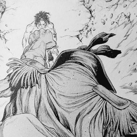 Photograph of the interior of Volume 2 of One Piece Ace's Story The Manga showing a black and white manga panel. Image shows Whitebeard from behind with his left fist out toward Ace, who is standing.