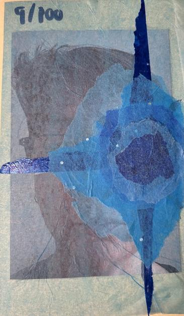 A photo of the face of a white Worman with short brown hair and rectangular glasses with dark frames. Her face is covered with layers of blue semitransparent tissue paper, centering on her left eye, in a starburst shape.