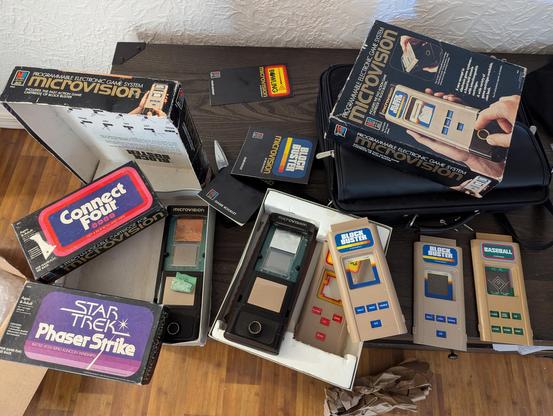 All the microvisions and their boxes and loose carts and some cart boxes and manuals in a pile on my table