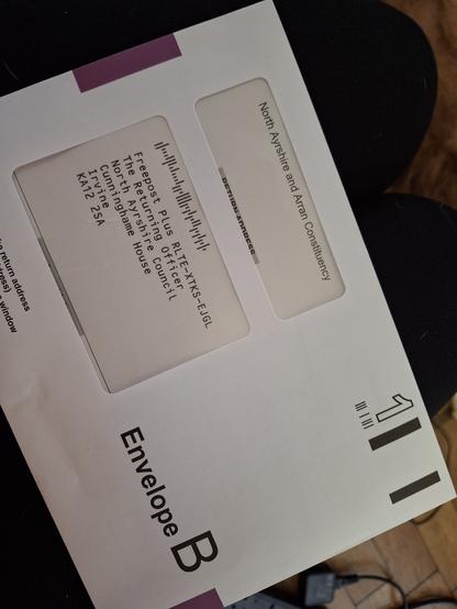 A photograph of an official, sealed first class envelope with the address of North Ayrshire Council's returning officer on it.