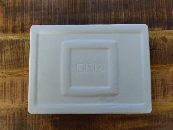 A white cardboard holder for the keycaps that was inside the box