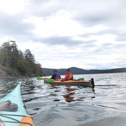 View of ocean & friends in double kayak in front of us.