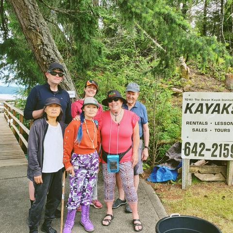 Group photo of me, my Mom & 4 paddling friends at Rush Adventures kayaking, in front of boardwalk to their docks.