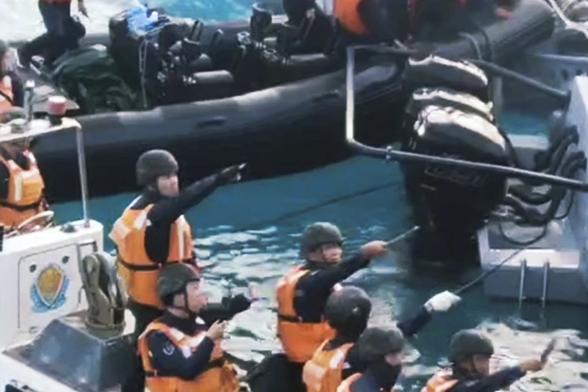FILE - In this handout photo provided by Armed Forces of the Philippines, Chinese Coast Guard hold knives and machetes as they approach Philippine troops on a resupply mission in the Second Thomas Shoal at the disputed South China Sea on June 17, 2024. The president of the Philippines said Sunday, June 23, 2024, his country would not yield to “any foreign power” after Chinese forces injured Filipino navy personnel and damaged at least two military boats with machetes, axes and hammers in a clash in the disputed South China Sea, but added the Philippines would never instigate a war.(Armed Forces of the Philippines via AP, File)