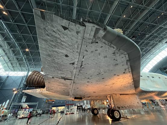 Photo of the underwing, landing gear and an engine nozzle of Space Shuttle Discovery.