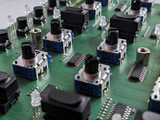 Detail shot of a printed circuit board with potentiometers and microcontrollers