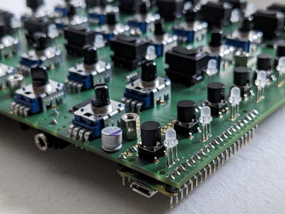 Detail shot of a printed circuit board with LEDs and a raspberry pico microcontroller