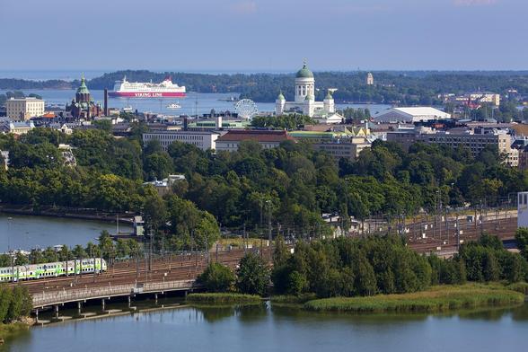 Aerial image of Helsinki city center in summer with trees, sea and buildings
