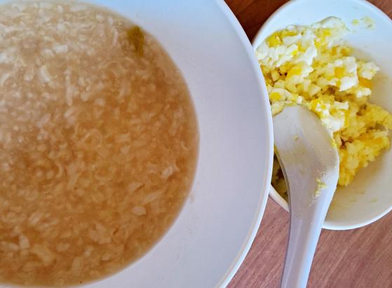 Beef broth rice congee with smooshed up boiled eggs.