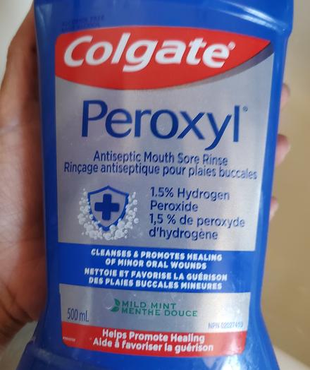 500mL blue bottle of Colgate Peroxyl antiseptic mouth sore rinse. Mild mint flavor.