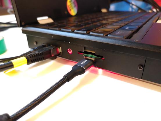The outaide of the reform. A USB C cable is plugged into it, right beneath the SD card slot.