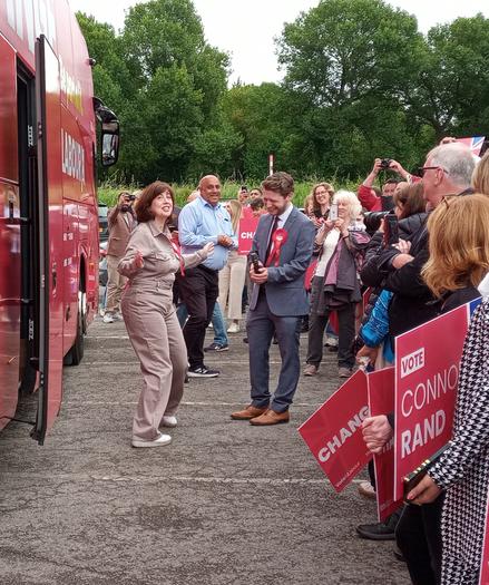 Lucy Powell, Connor Rand and fans outside the Labour battle bus