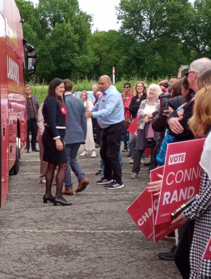 Lisa Nandy, Connor Rand (turning away) and fans outside the Labour battle bus