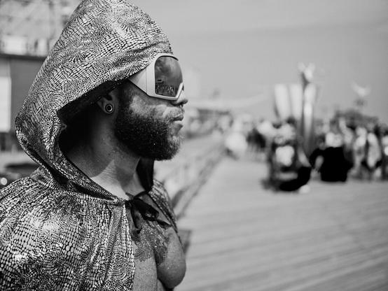 Costumed individual at Coney Island Mermaid Parade, exemplifying celebration, joy and cosplay culture on the beachside boardwalk of Brooklyn.