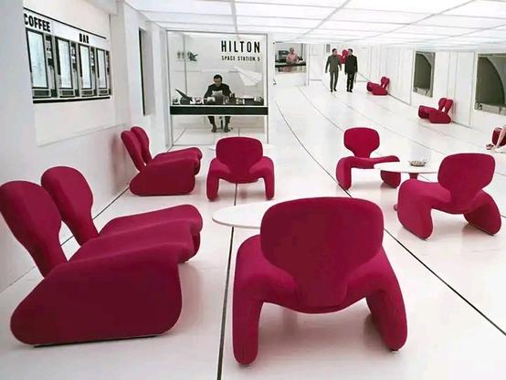 2001 space odyssey orbiting Hilton hotel with Djinn pink chairs in all white room