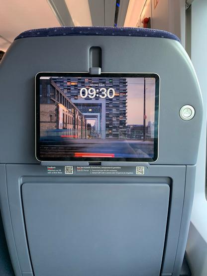 iPad in a dedicated holder on the back of a train seat