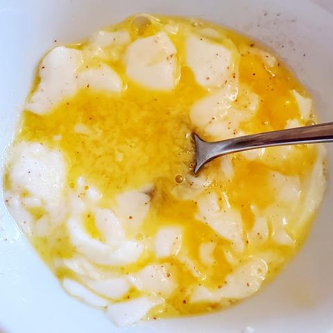 2 soft boiled eggs - finely minced. In white bowl with silver plate spoon.