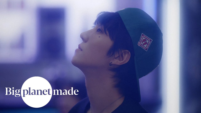 Promo Image for Criminal. BE'O is in profile and is wearing a green baseball hat and looking up