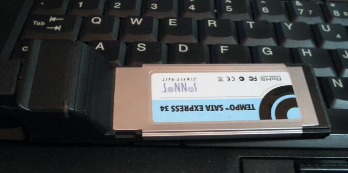 an Sonnet Tempo SATA Express Card 34 with 2 eSATA Ports sitting on an Lenovo laptop keyboard