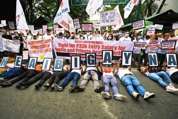 BENEFITS. Healthcare workers from various hospitals stage a protest in front of the Department of Health office in Manila, asking the agency to immediately release their Health Emergency Allowance and a wage increase