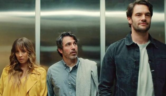 Kaley Cuoco, Chris Messina and Tom Bateman stand in an elevator. They all face forward.