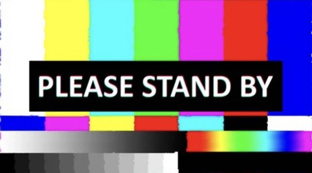 PLEASE STAND BY

Emergency broadcast rainbow screen that usually is accompanied by a shrill sound