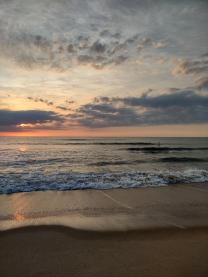 Beach, Ocean, Orange sunrise, lone bird low over the water.