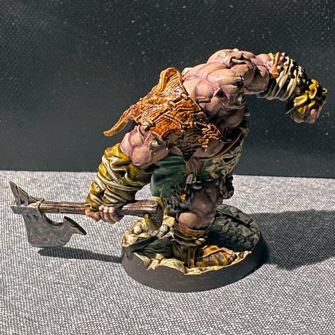Same figure, but with some sewn leather panels over the shoulder of the arm that's holding the axe.