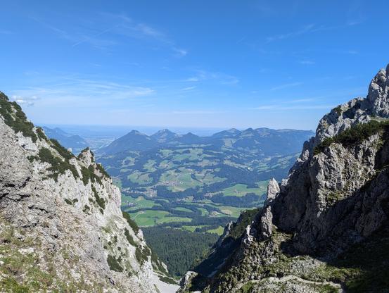 View down a narrow valley. Rough limestone, lots and lots of gravel and an old path withering in the rough mountain climate