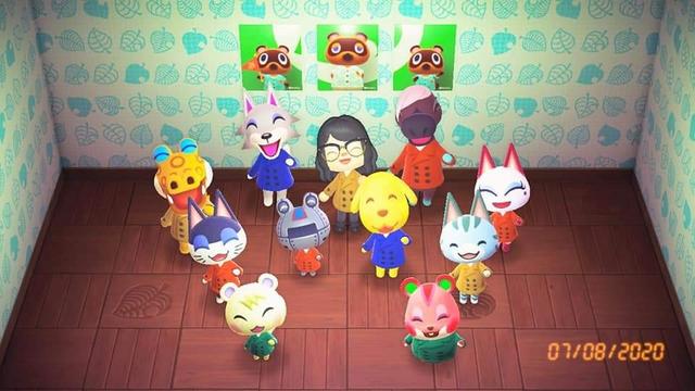 my acnh character with all ten residents with a poster of tom nook, timmy, and tommy