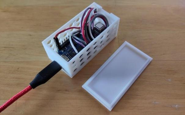 Photo of a D1 mini board connected to an SCD40 CO2 sensor module, installed in a 3D-printed case, and powered by USB-C cable.