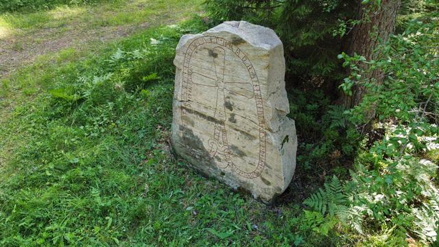 Photo of a gray runestone from above.  Sö 34.