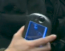 Samatha Carter (Played by Amada Tapping) holding a PDA (presumably a Tapwave Zodiac) as a tool in a scene of Stargate SG-1